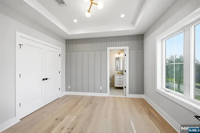 a view of hallway with a large window and wooden floor