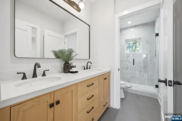a view of a hallway with bathroom and window