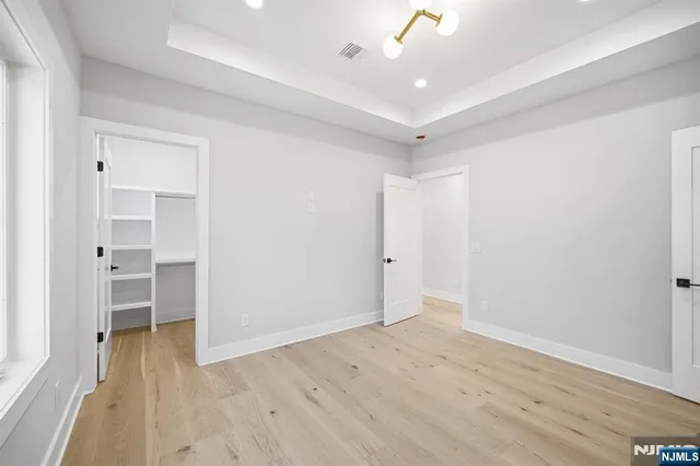 a spacious bedroom with a bed and a large window