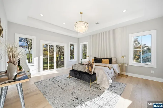 a spacious bedroom with a bed and a large window