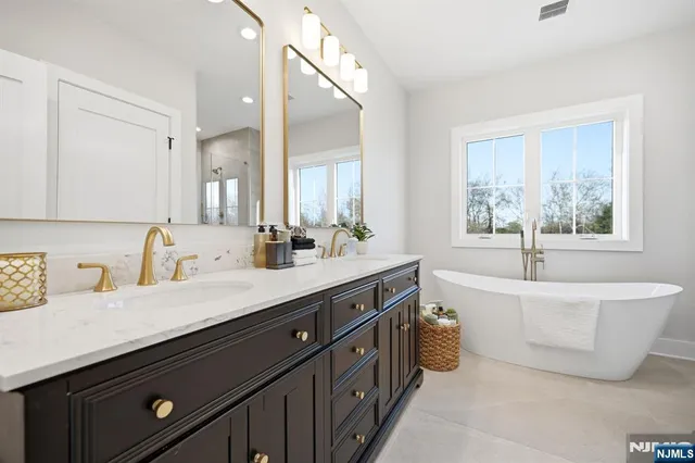 a white bath tub sitting next to a shower