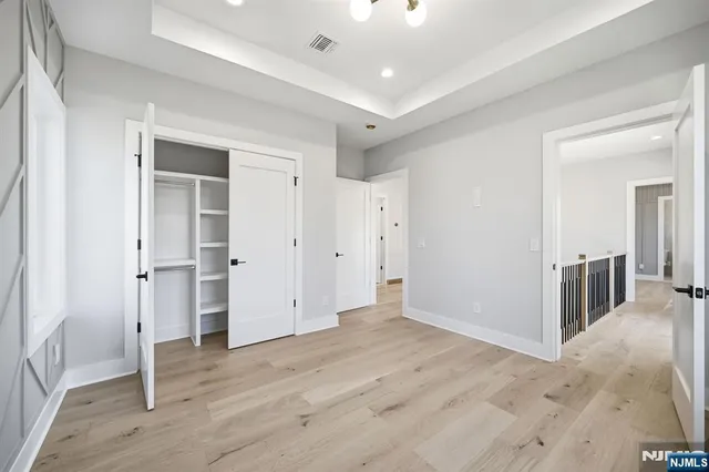 a view of a hallway with wooden floor and entryway