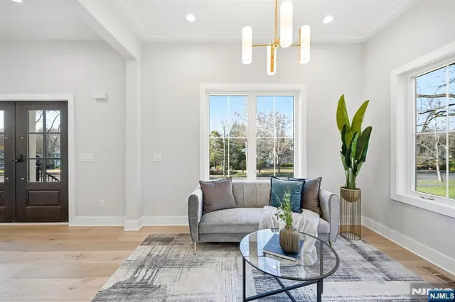 a living room with furniture a window and a potted plant