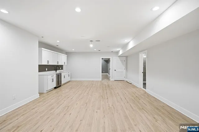 a large white kitchen with a white wooden cabinets and white appliances