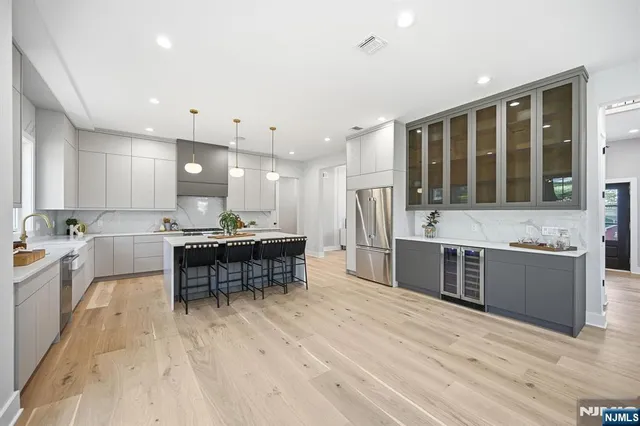 a large kitchen with stainless steel appliances kitchen island granite countertop a sink and cabinets