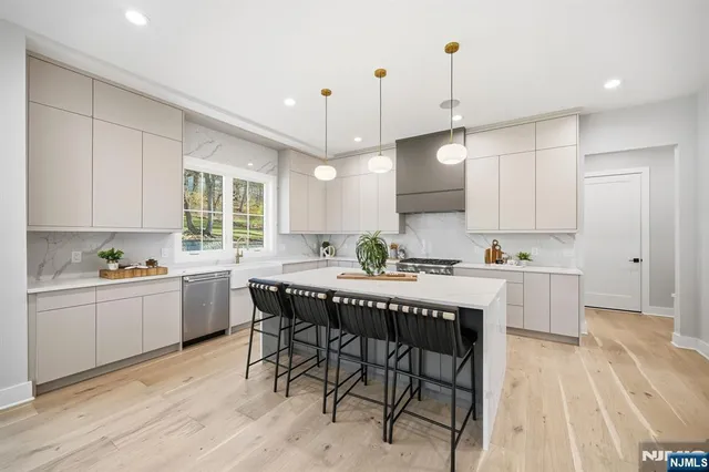 a kitchen with a table chairs sink and cabinets