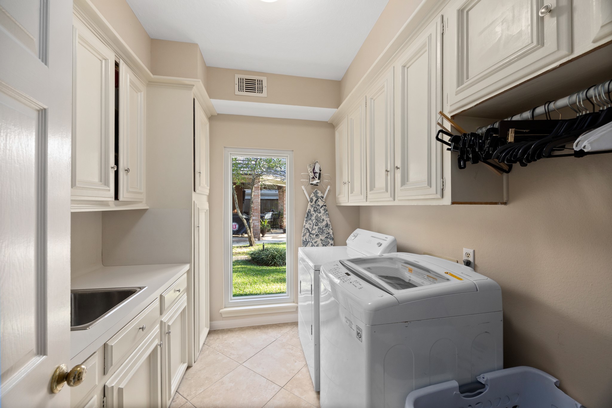 8807 Chelmsford Lane Spring, TX 77379 - Photo 19 of 50 The utility room features room for a fridge, a sink, ample built in storage and a new energy efficient window overlooking the back yard.
