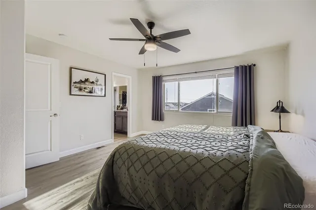 a bedroom with a large bed and a large window