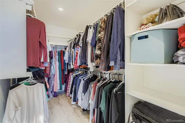 a view of walk in closet with clothes