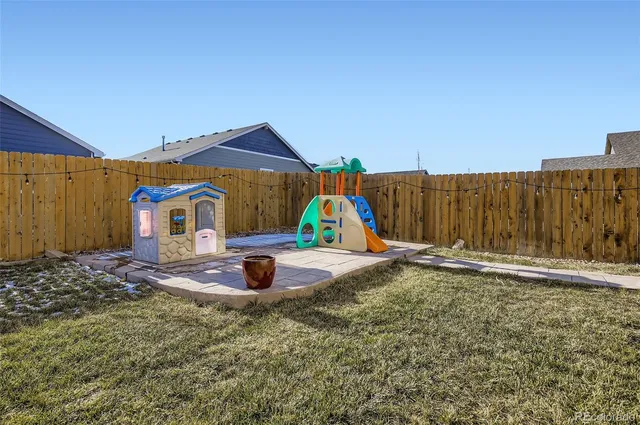 a backyard of a house with trampoline