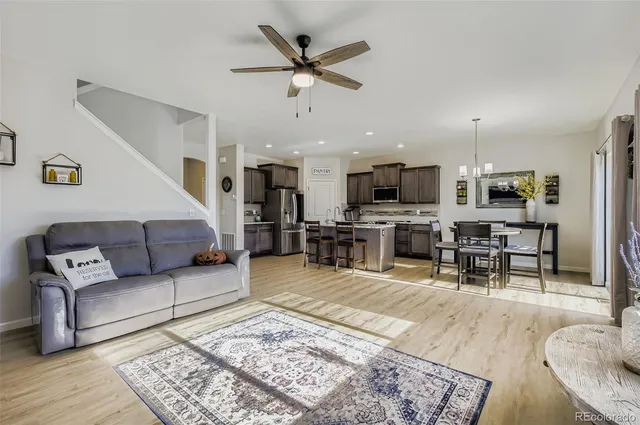 a living room with furniture and kitchen view