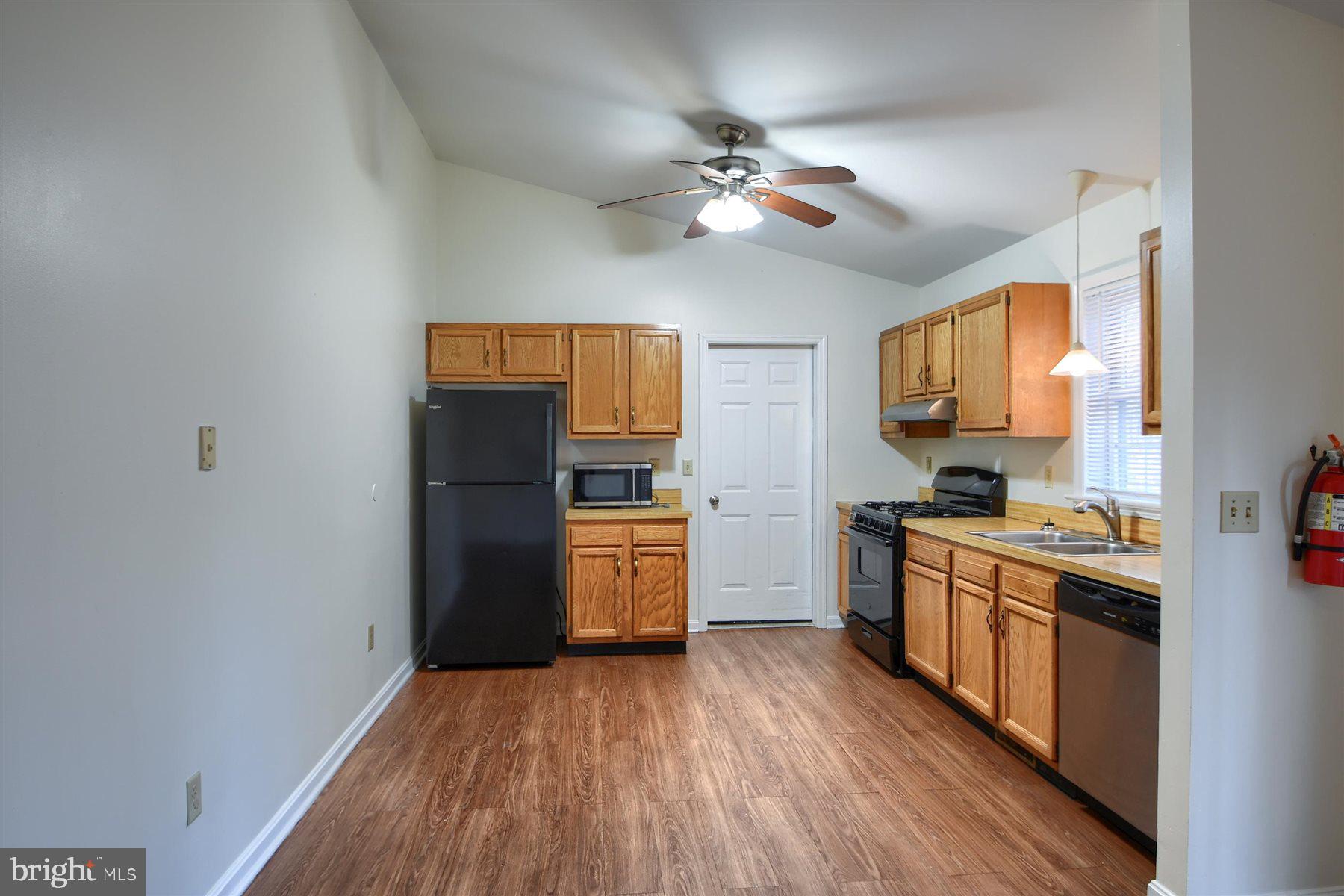401 Dalton Road Oxford, PA 19363 - Photo 14 of 37 a kitchen with a wooden floor stove top oven and refrigerator