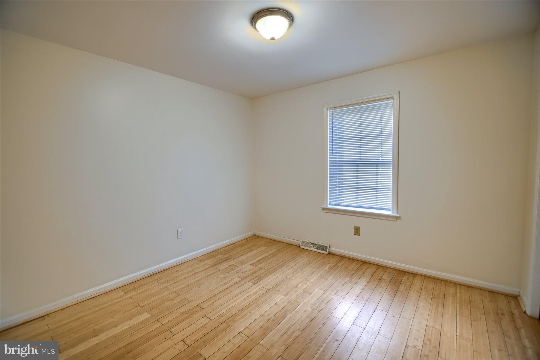 401 Dalton Road Oxford, PA 19363 - Photo 22 of 37 an empty room with wooden floor and windows