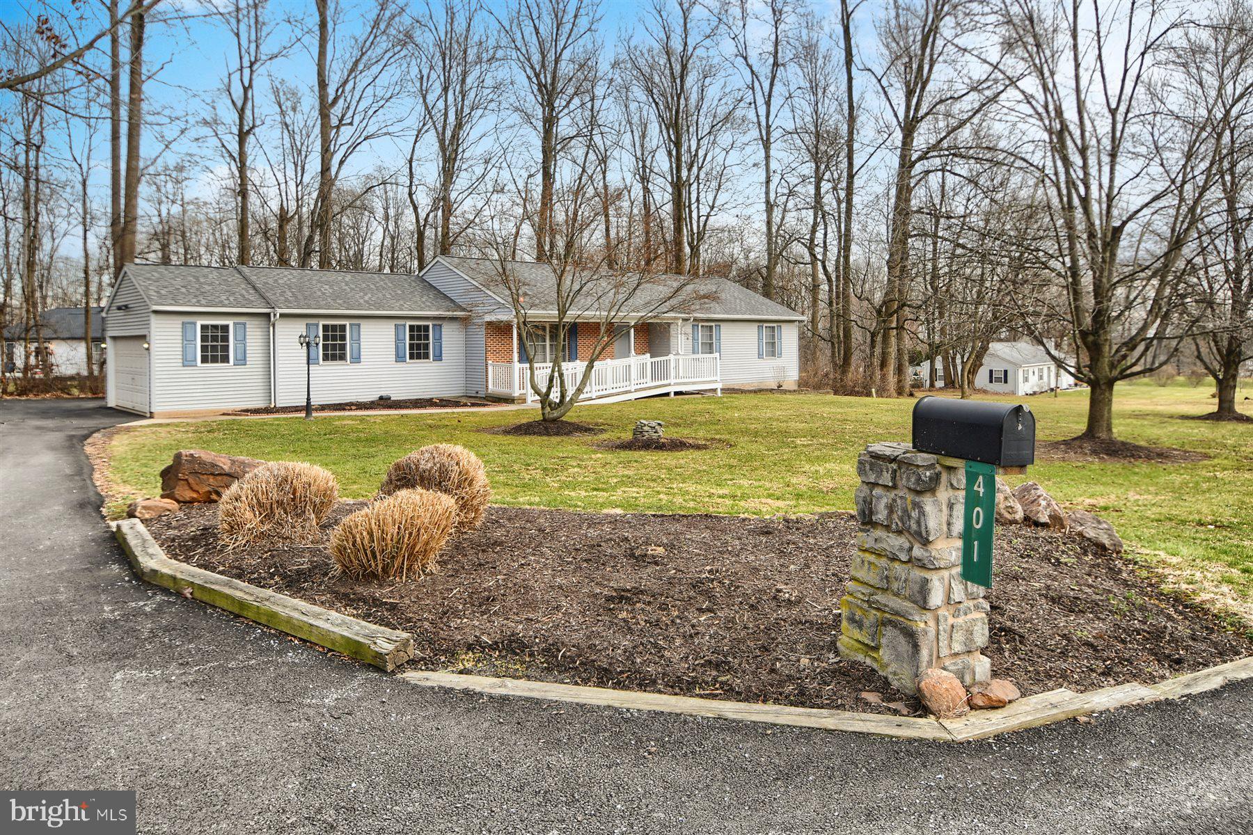 401 Dalton Road Oxford, PA 19363 - Photo 7 of 37 a front view of a house with a garden and trees