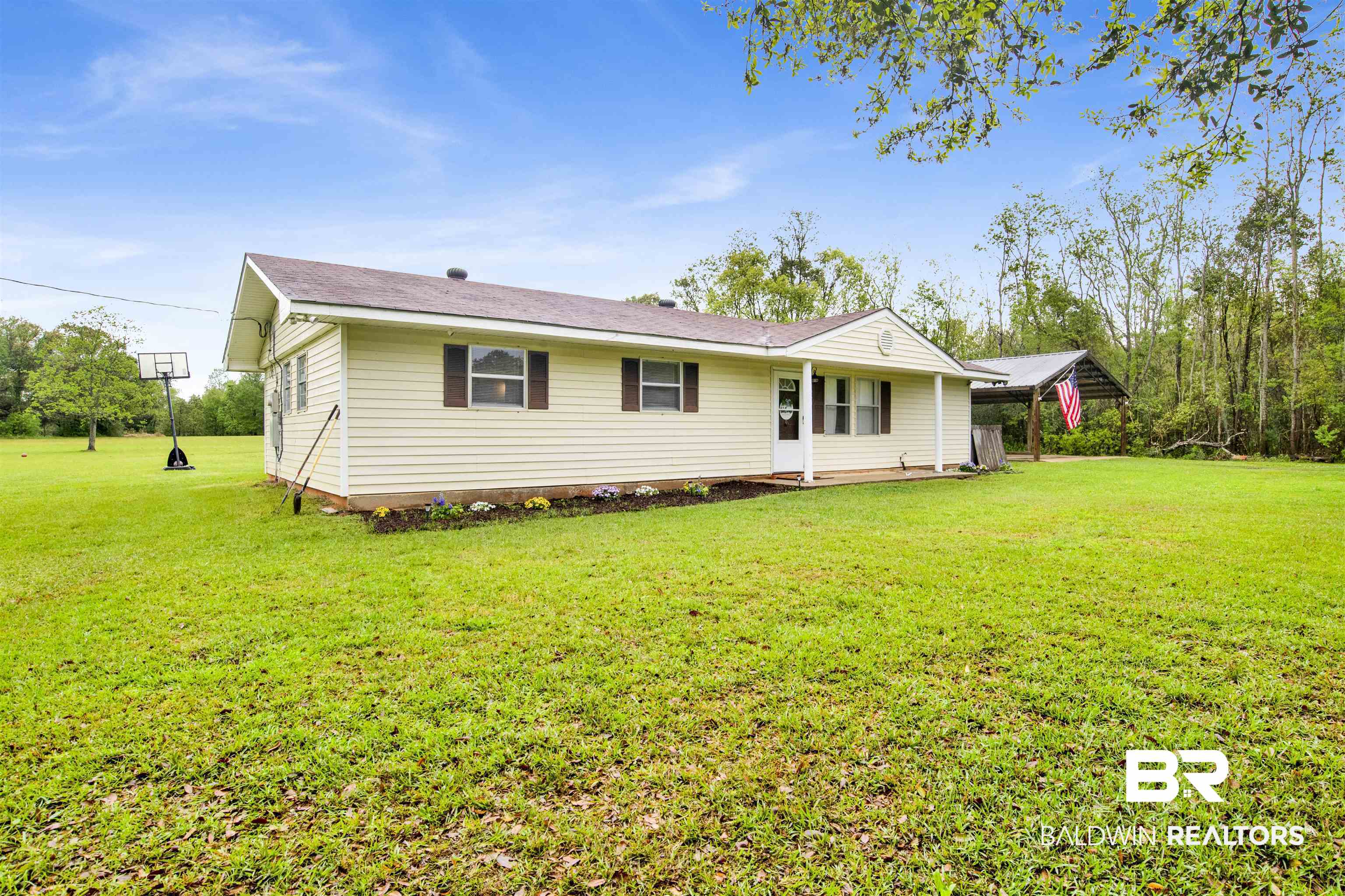 10244 Magnolia Road Irvington, AL 36544 - Photo 30 of 37 Rear view of property with a yard