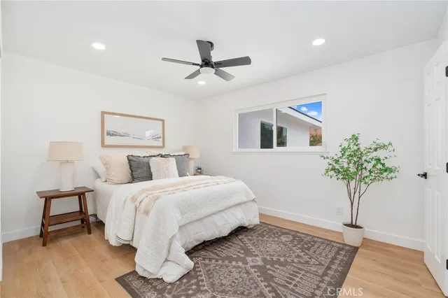 a bedroom with a bed and a potted plant