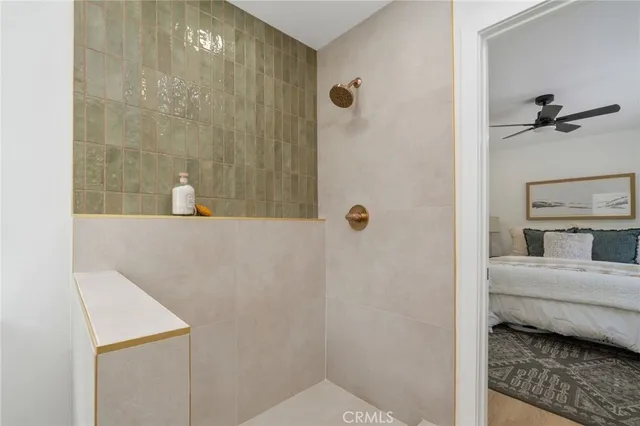 a bathroom with a granite countertop sink a mirror and shower