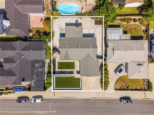 an aerial view of a multiple houses with a street