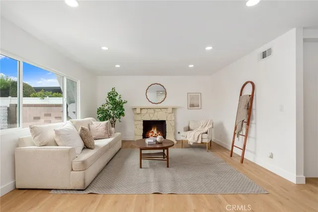 a living room with furniture a fireplace and a table