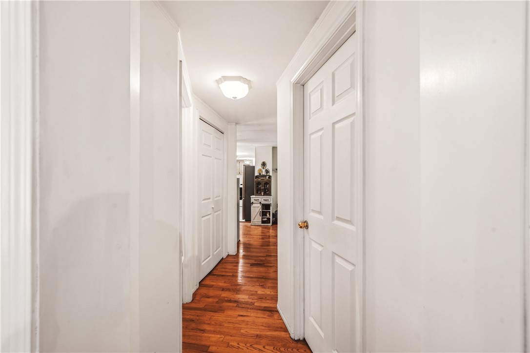 942 Chambers Hill Road Seneca, SC 29672 - Photo 14 of 38 A well-lit corridor boasts rich hardwood flooring leading to additional rooms.