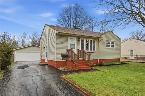 a view of a house with backyard and sitting area