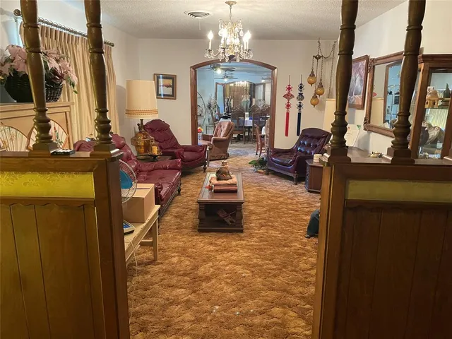 a living room with fireplace furniture and a chandelier