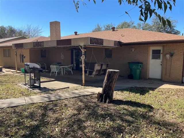 a front view of a house with barbeque grill and outdoor seating