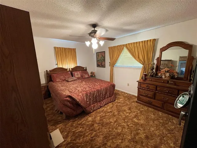 a bedroom with a bed and a dresser with the outer view