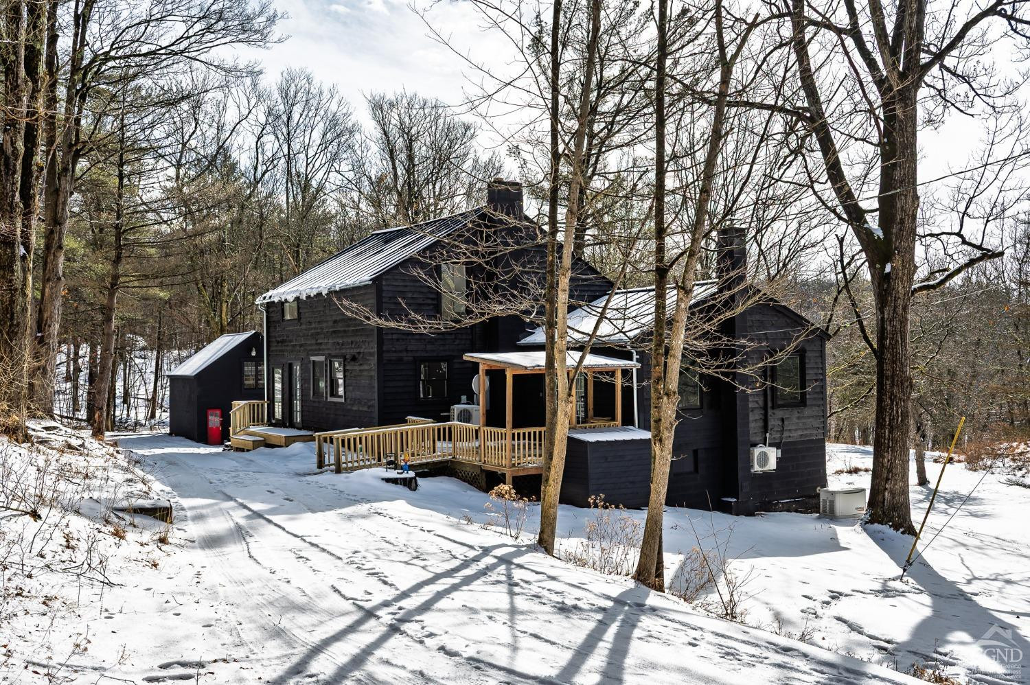 a view of a house with a snow on the road