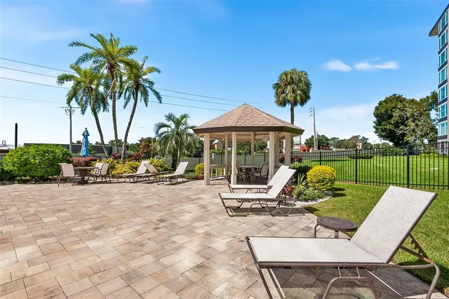a view of a backyard with swimming pool and furniture