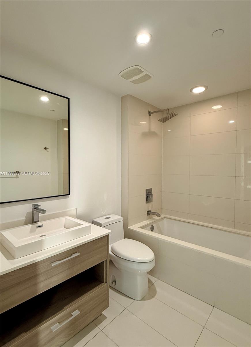 1300 South Miami Avenue, Unit 2008 Miami, FL 33130 - Photo 23 of 29 a bathroom with a bathtub shower sink mirror vanity and toilet