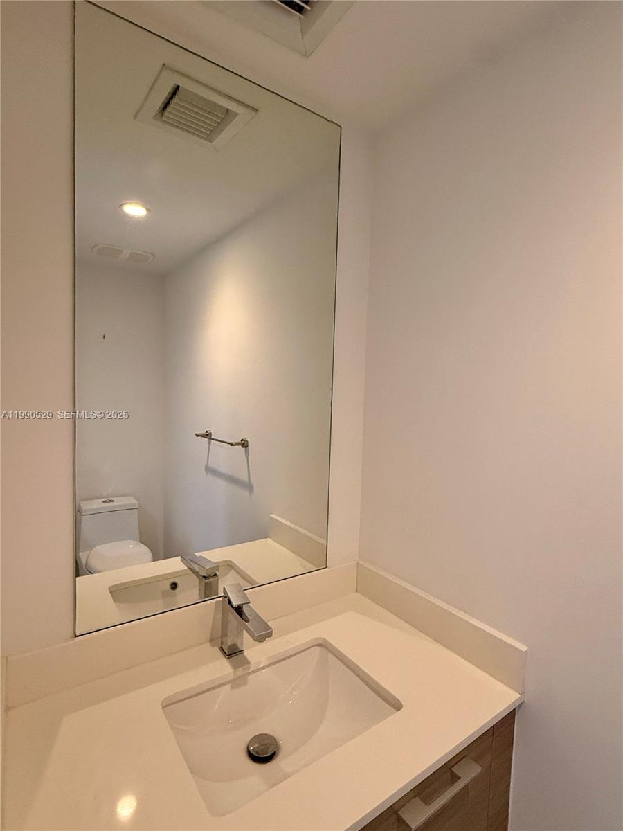 1300 South Miami Avenue, Unit 2008 Miami, FL 33130 - Photo 24 of 29 a bathroom with a sink and a mirror