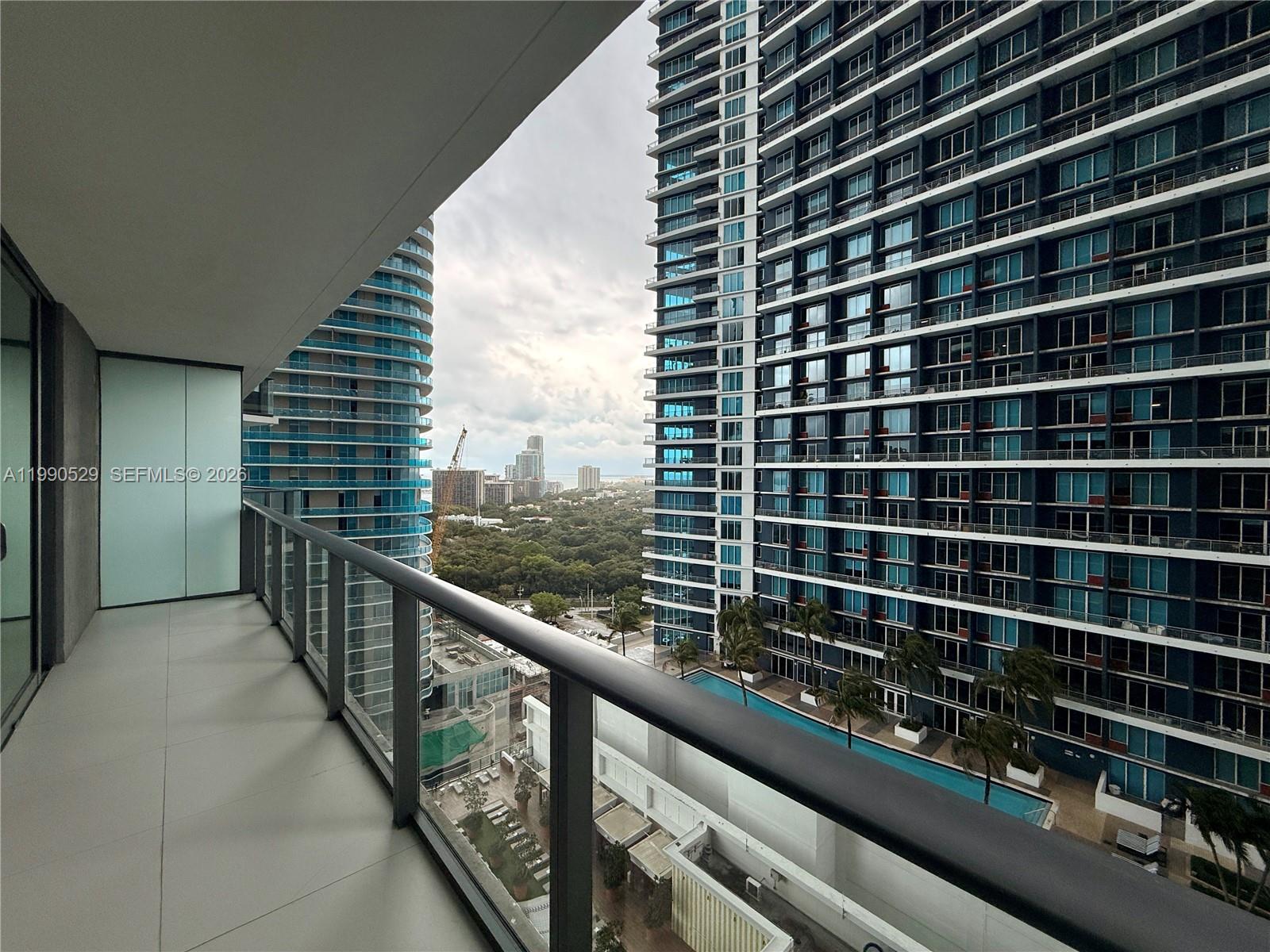 1300 South Miami Avenue, Unit 2008 Miami, FL 33130 - Photo 8 of 29 a view of a balcony with wooden floor and windows