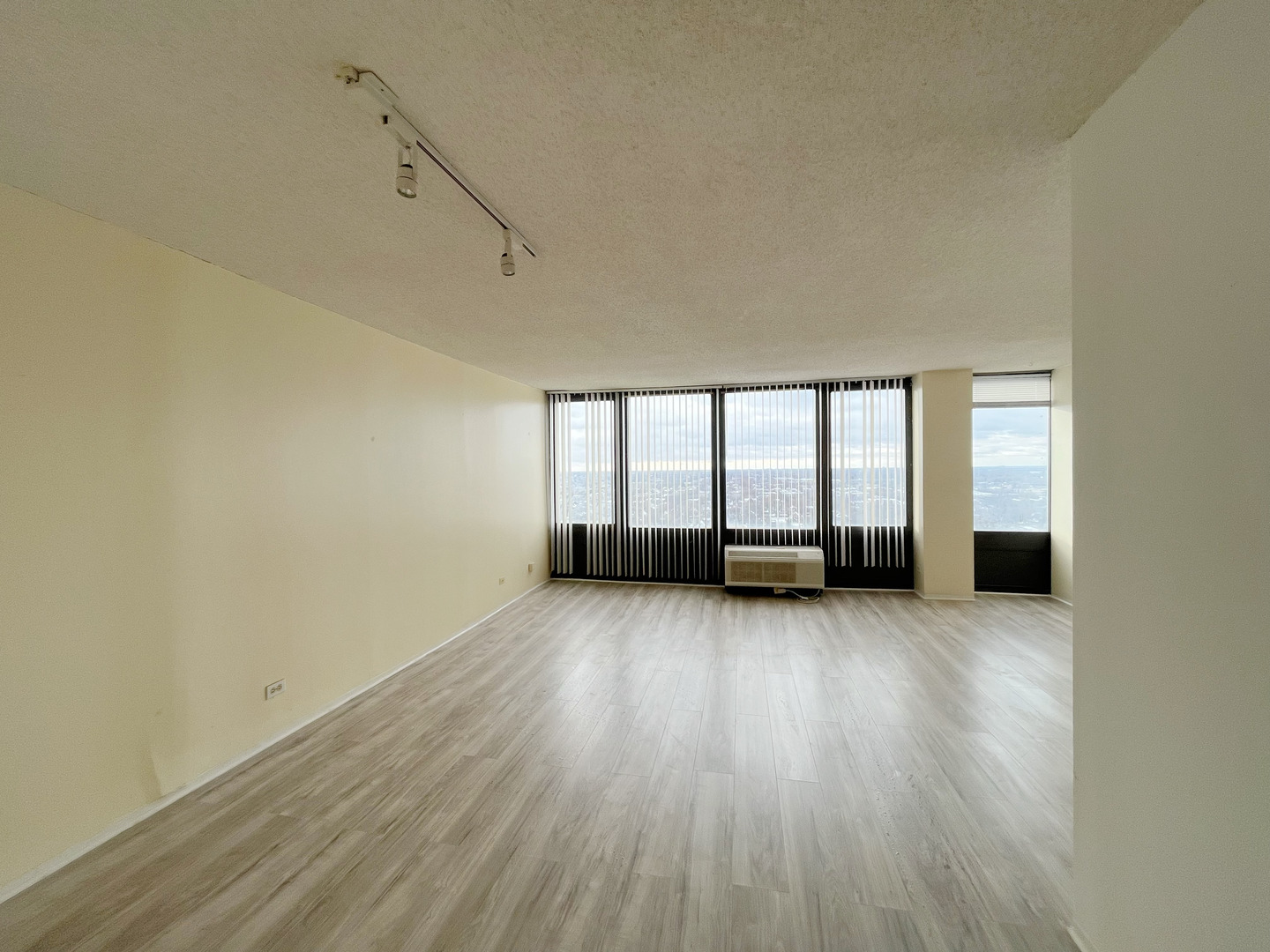 5320 North Sheridan Road, Unit 2110 Chicago, IL 60640 - Photo 10 of 16 wooden floor in an empty room with a window