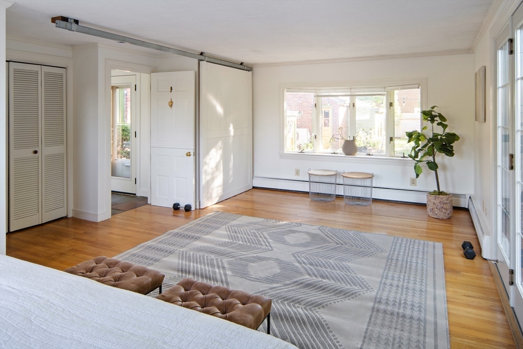 263 Common Street Belmont, MA 02478 - Photo 11 of 31 a view of a bedroom with wooden floor and a potted plant
