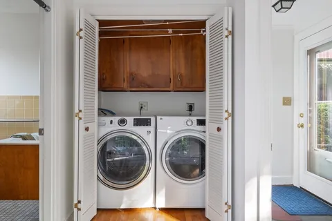 a view of a hallway with washer and dryer