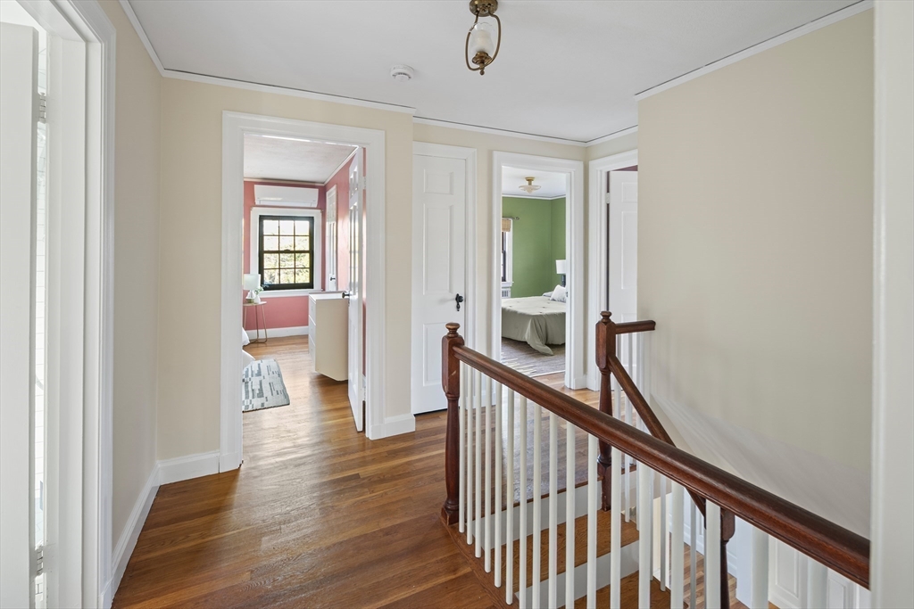 263 Common Street Belmont, MA 02478 - Photo 15 of 31 a view of a hallway with wooden floor and stairs