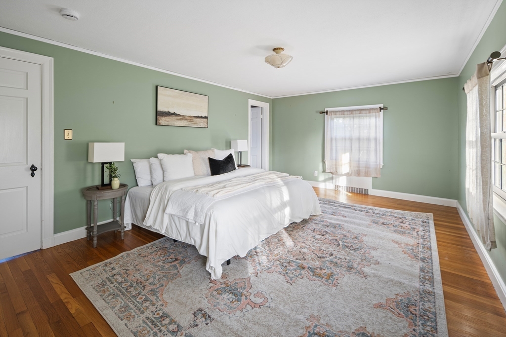 263 Common Street Belmont, MA 02478 - Photo 16 of 31 a bedroom with a bed and wooden floor