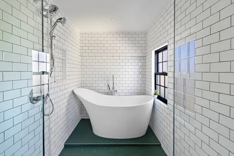 a white bath tub sitting in a bathroom