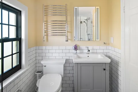 a bathroom with a toilet a sink and a mirror