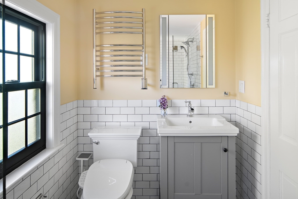 263 Common Street Belmont, MA 02478 - Photo 18 of 31 a bathroom with a toilet a sink and a mirror