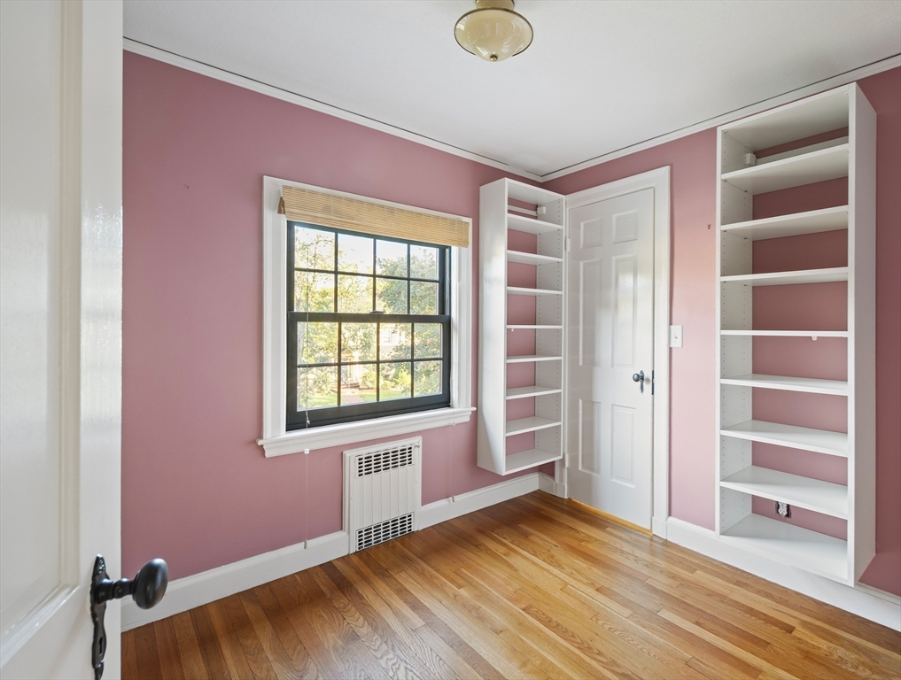 263 Common Street Belmont, MA 02478 - Photo 19 of 31 a view of an empty room with a window and wooden floor
