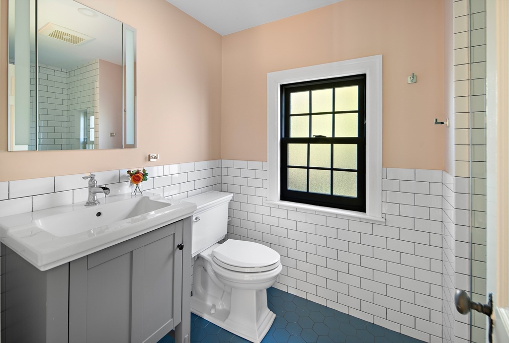 263 Common Street Belmont, MA 02478 - Photo 22 of 31 a bathroom with a sink toilet a mirror and shower