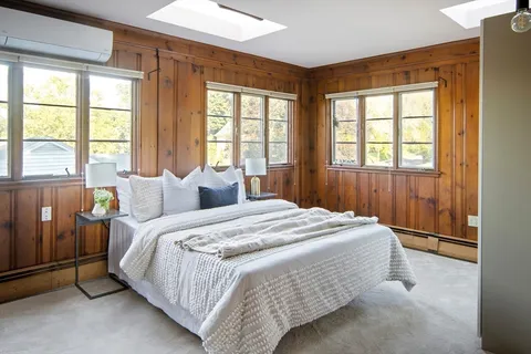 a spacious bedroom with a bed and a window