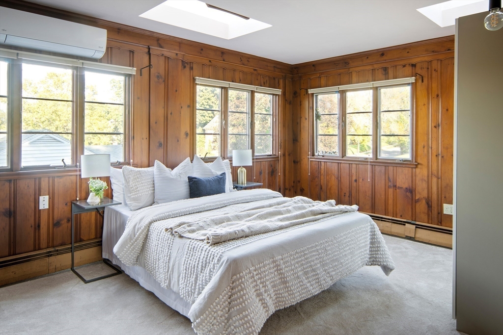263 Common Street Belmont, MA 02478 - Photo 24 of 31 a spacious bedroom with a bed and a window