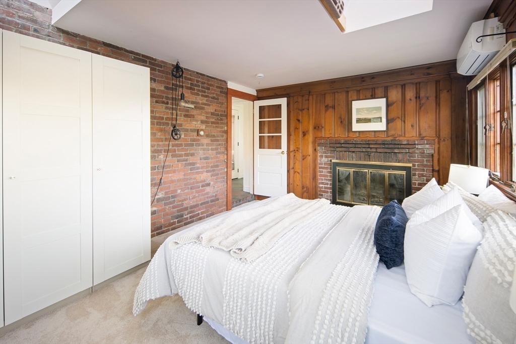 263 Common Street Belmont, MA 02478 - Photo 25 of 31 a bedroom with a bed and a flat screen tv