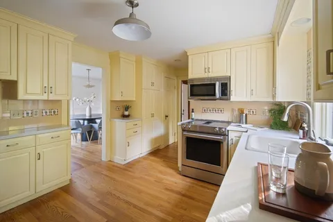 a kitchen with stainless steel appliances a stove sink and cabinets