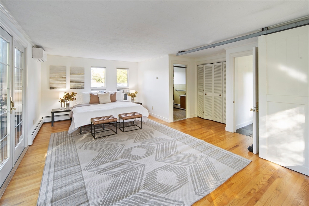 263 Common Street Belmont, MA 02478 - Photo 10 of 31 a spacious bedroom with a bed and large windows