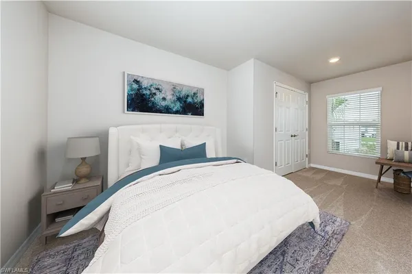 a spacious bedroom with a bed and a window
