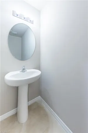 a bathroom with a sink a mirror and toilet